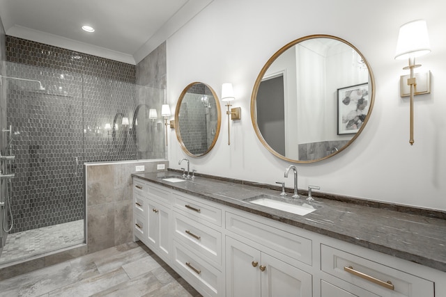 bathroom featuring crown molding, vanity, and tiled shower