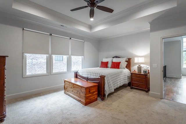 carpeted bedroom with crown molding, ceiling fan, and multiple windows