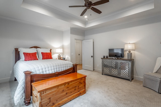 bedroom featuring a raised ceiling, ceiling fan, and light carpet