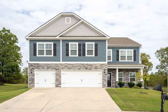 craftsman house with a front yard and a garage