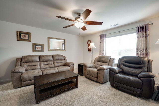 carpeted living room with ceiling fan