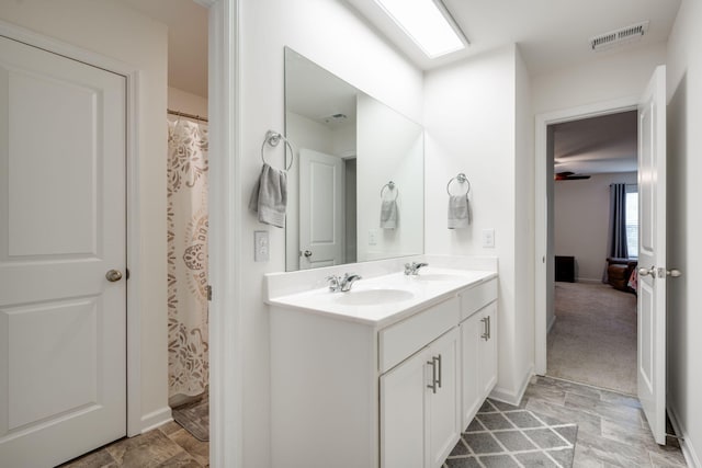 bathroom with walk in shower and vanity