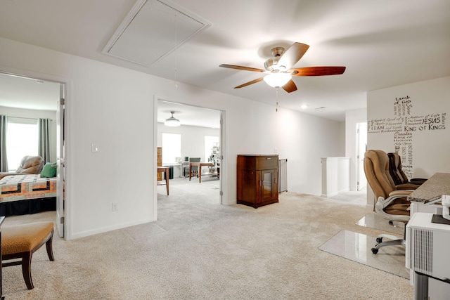 home office with light carpet and ceiling fan