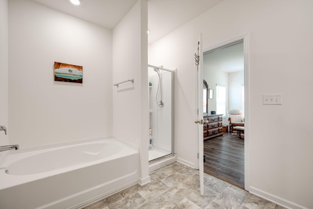 bathroom featuring shower with separate bathtub and hardwood / wood-style floors