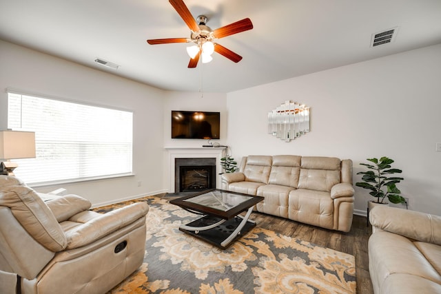 living room with wood-type flooring and ceiling fan