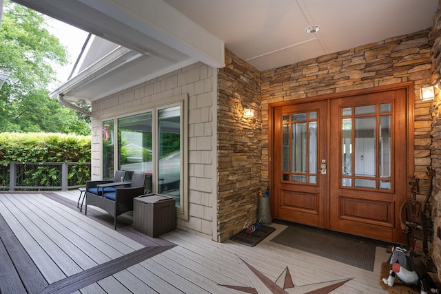 entrance to property featuring french doors and a deck