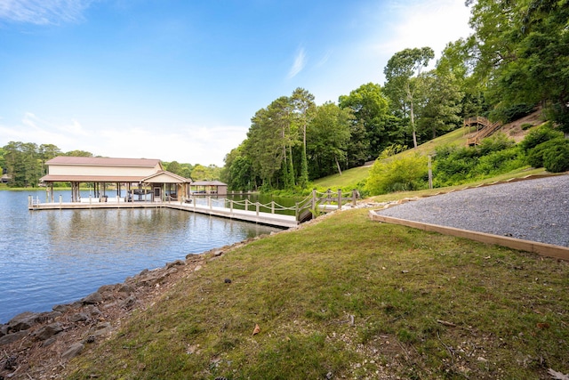 dock area featuring a lawn and a water view