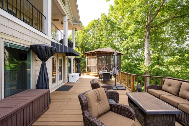 wooden terrace with french doors and an outdoor hangout area