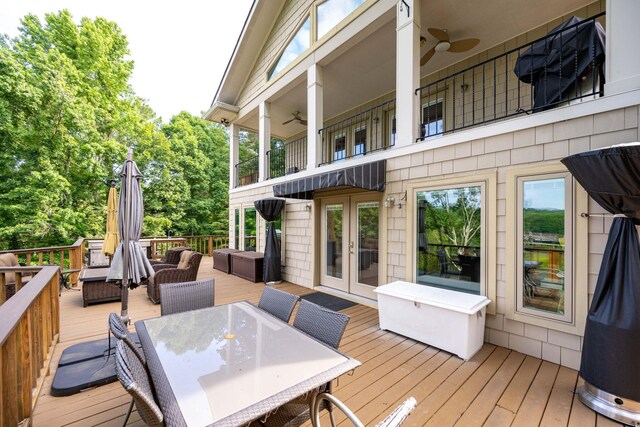 wooden deck with ceiling fan, an outdoor living space, and french doors