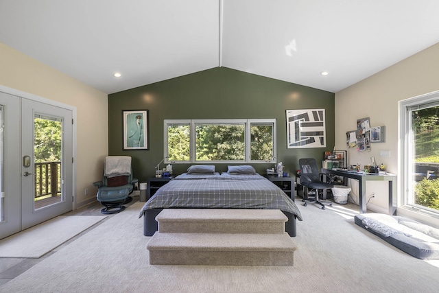 carpeted bedroom featuring access to outside, lofted ceiling, and french doors