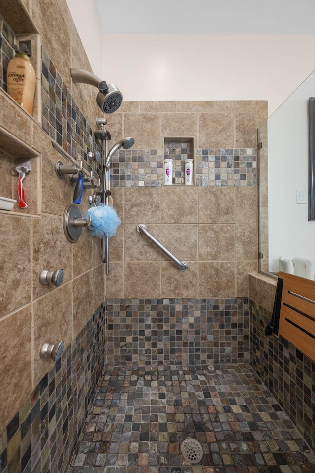 bathroom with tiled shower