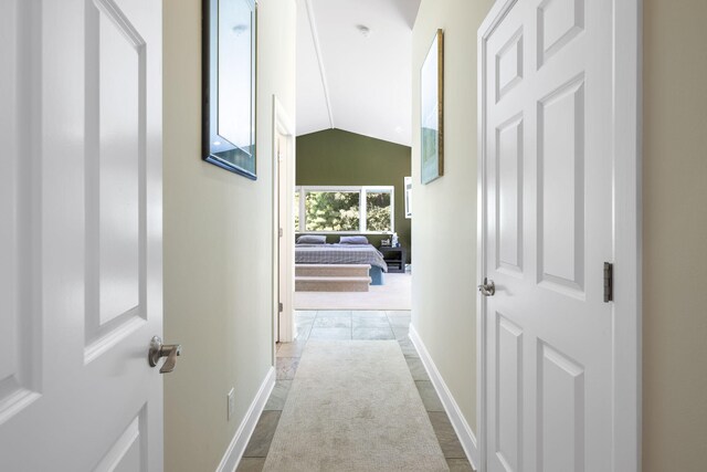 corridor featuring lofted ceiling