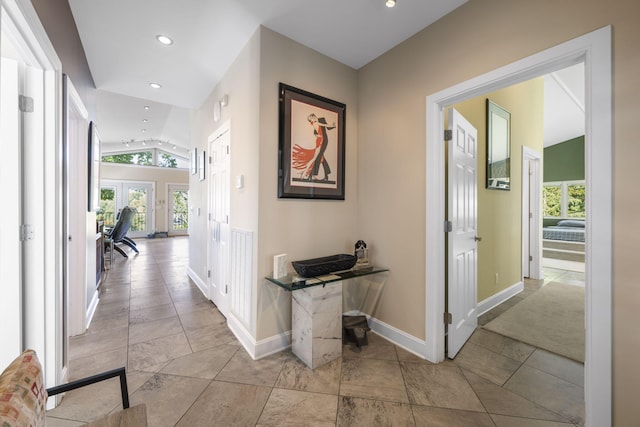 corridor featuring vaulted ceiling and french doors