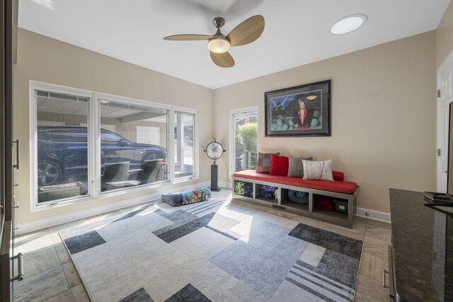 interior space with ceiling fan