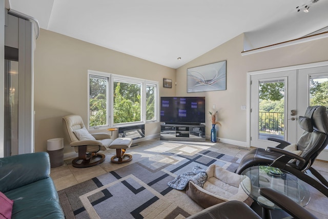 tiled living room featuring vaulted ceiling, plenty of natural light, and french doors