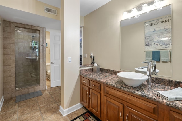 bathroom featuring vanity, toilet, and a shower with door