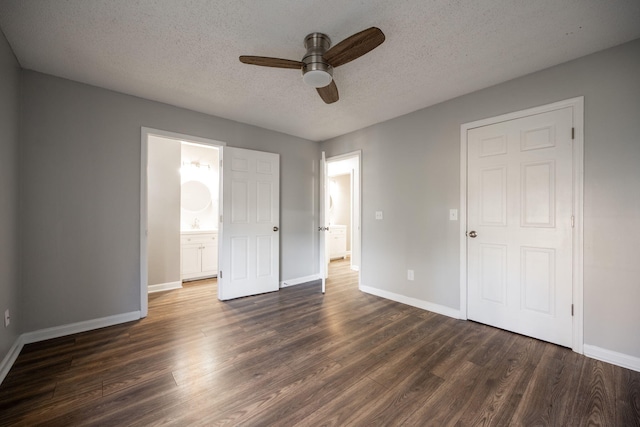 unfurnished bedroom with ceiling fan, dark hardwood / wood-style floors, ensuite bathroom, and a textured ceiling