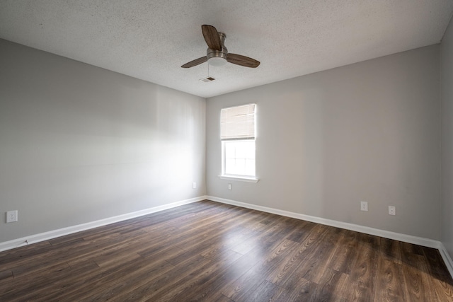 spare room featuring a textured ceiling, ceiling fan, and dark wood-type flooring