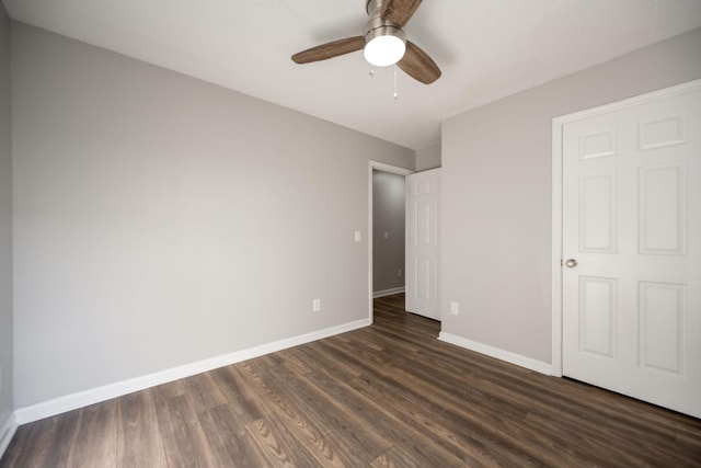 unfurnished bedroom featuring ceiling fan and dark hardwood / wood-style floors