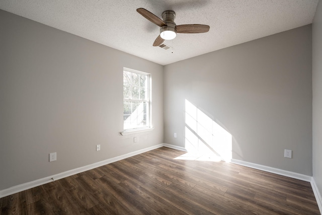 unfurnished room featuring ceiling fan, dark wood-type flooring, and a textured ceiling