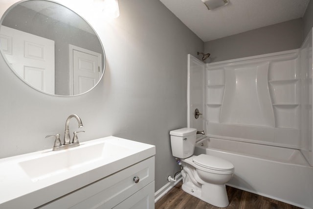 full bathroom featuring vanity, toilet, washtub / shower combination, and hardwood / wood-style flooring