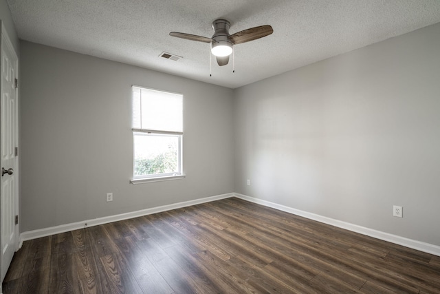 spare room with ceiling fan, dark wood-type flooring, and a textured ceiling