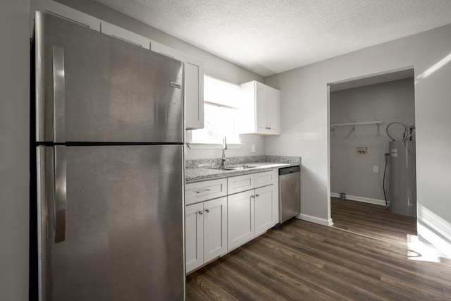 kitchen with a textured ceiling, stainless steel appliances, dark wood-type flooring, sink, and white cabinetry