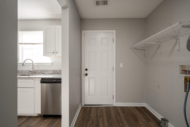 laundry room with sink, dark wood-type flooring, and hookup for a washing machine