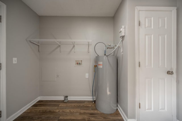 washroom with hookup for an electric dryer, hookup for a washing machine, dark hardwood / wood-style floors, and water heater