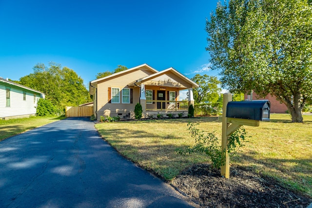 bungalow-style house with a porch and a front lawn