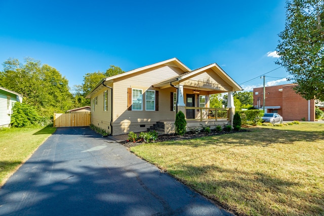 bungalow-style home with a front lawn and covered porch