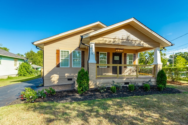 bungalow with a front lawn and a porch