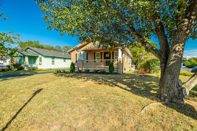 bungalow-style house with a front lawn and a porch