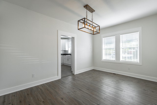 interior space featuring dark wood-type flooring and a notable chandelier