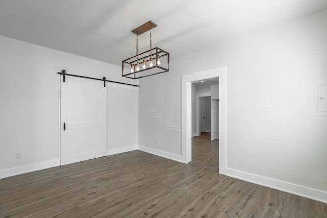 14 N Parkdale Ave, Chattanooga, TN 37411 - unfurnished dining area with a barn door, baseboards, and wood finished floors