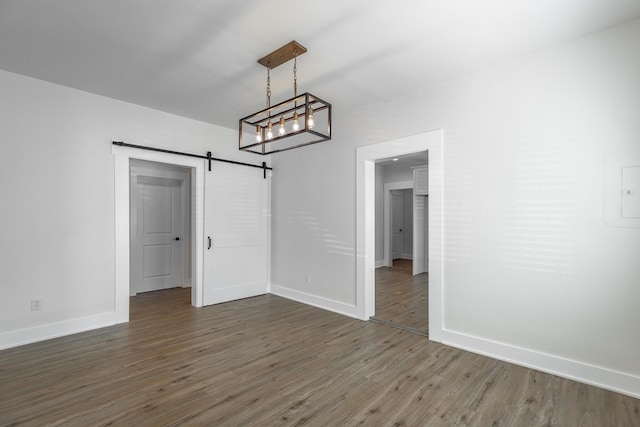 14 N Parkdale Ave, Chattanooga, TN 37411 - unfurnished dining area with baseboards, a barn door, and wood finished floors