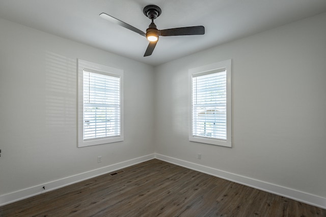 empty room featuring dark hardwood / wood-style floors and ceiling fan