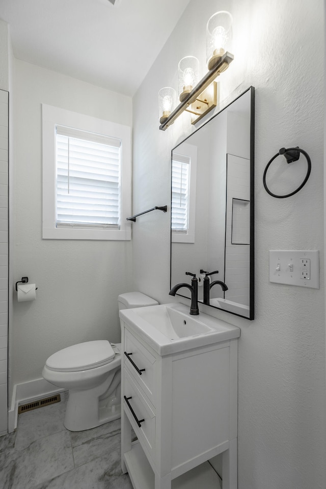 bathroom featuring vanity, toilet, and tile patterned floors