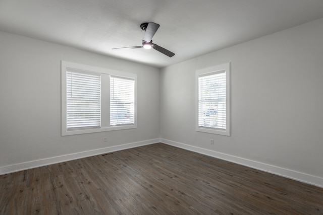 empty room with dark wood-type flooring and ceiling fan