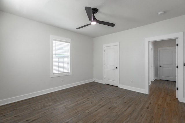 unfurnished bedroom featuring dark hardwood / wood-style floors, ceiling fan, and a closet