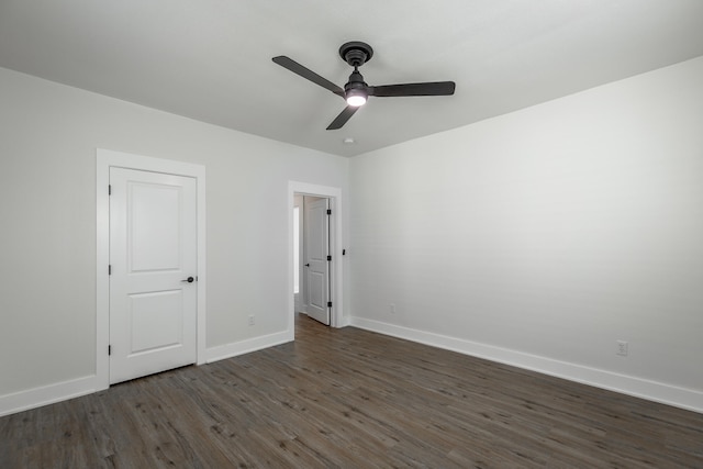 unfurnished bedroom with ceiling fan and dark hardwood / wood-style floors