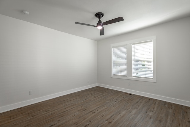 spare room featuring dark hardwood / wood-style floors and ceiling fan