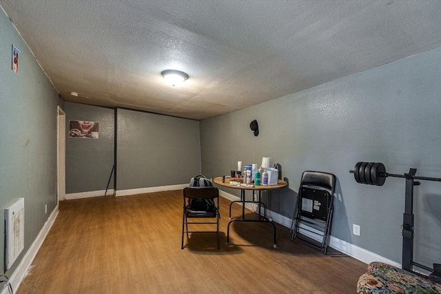 office with hardwood / wood-style floors and a textured ceiling