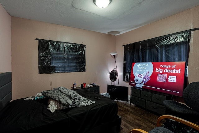 bedroom featuring a textured ceiling and hardwood / wood-style floors