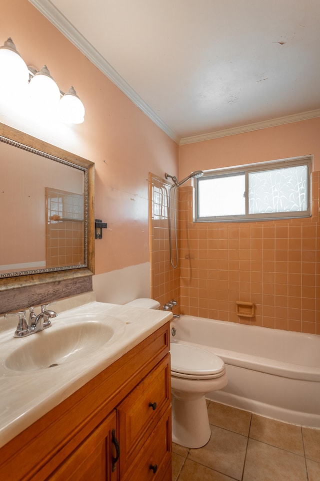 full bathroom featuring tiled shower / bath, vanity, toilet, crown molding, and tile patterned floors