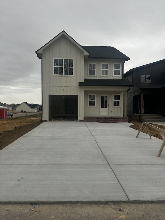 back of house featuring a garage