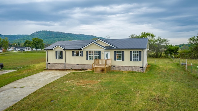 view of front facade with a mountain view and a front lawn