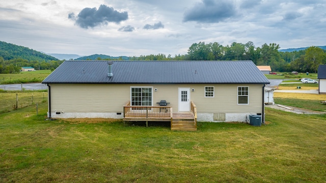 back of house featuring a deck with mountain view, a yard, and central air condition unit