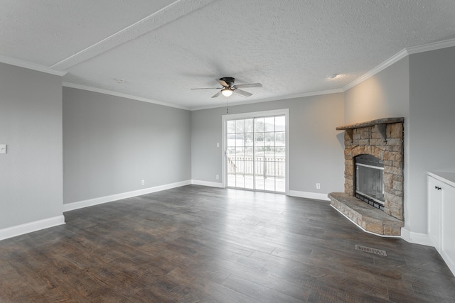 unfurnished living room with ceiling fan, ornamental molding, a textured ceiling, a fireplace, and dark hardwood / wood-style flooring