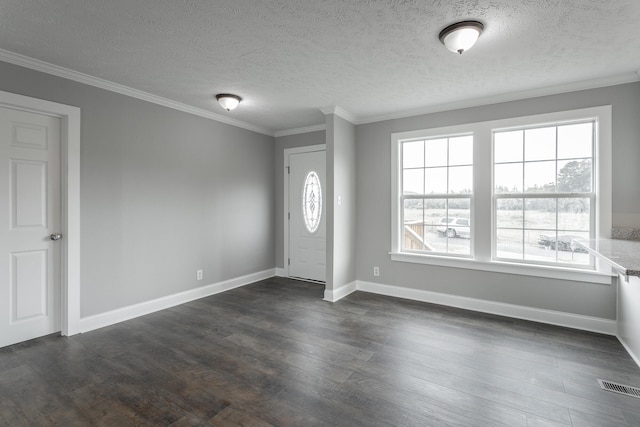 entrance foyer with a textured ceiling, dark hardwood / wood-style floors, and crown molding